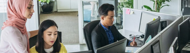 Image of employees having a quick discussion in the office