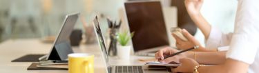 Image of employee using laptop in open concept office