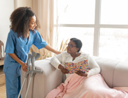 A black woman being comforted by a black female nurse